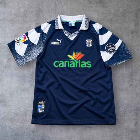 Camisola de futebol A minha loja Tenerife 1997/98 fora, azul marinho com detalhes brancos e logótipo da Puma.
