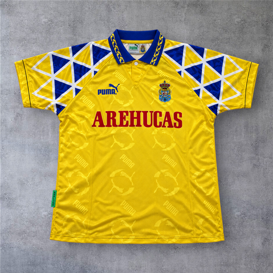 Camisola de futebol A minha loja Las Palmas 1995/96 amarela com padrão geométrico azul e branco e logótipo Puma