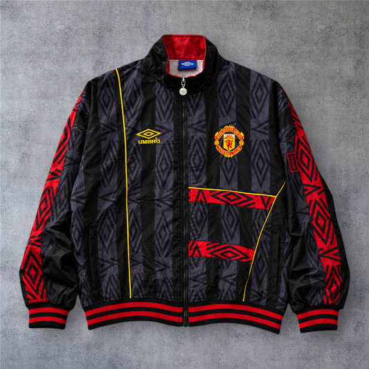Casaco vintage Manchester United 1993/94 A minha loja, preto com detalhes em vermelho e amarelo e fecho frontal.