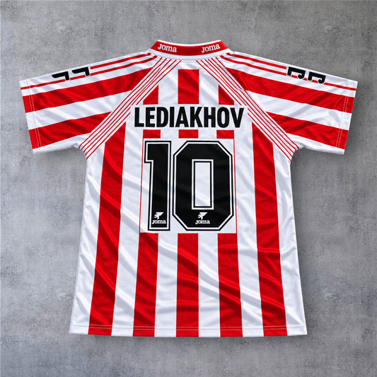Camisola de futebol A minha loja Sporting Gijon 1994/95, riscas vermelhas e brancas com nome Lediakhov e número 10.