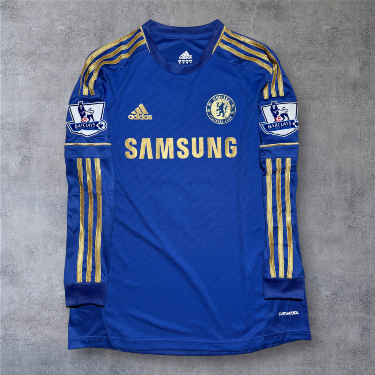 Camisola de futebol A minha loja Chelsea 2012/13 azul com detalhes dourados, mangas compridas e emblemas da Premier League