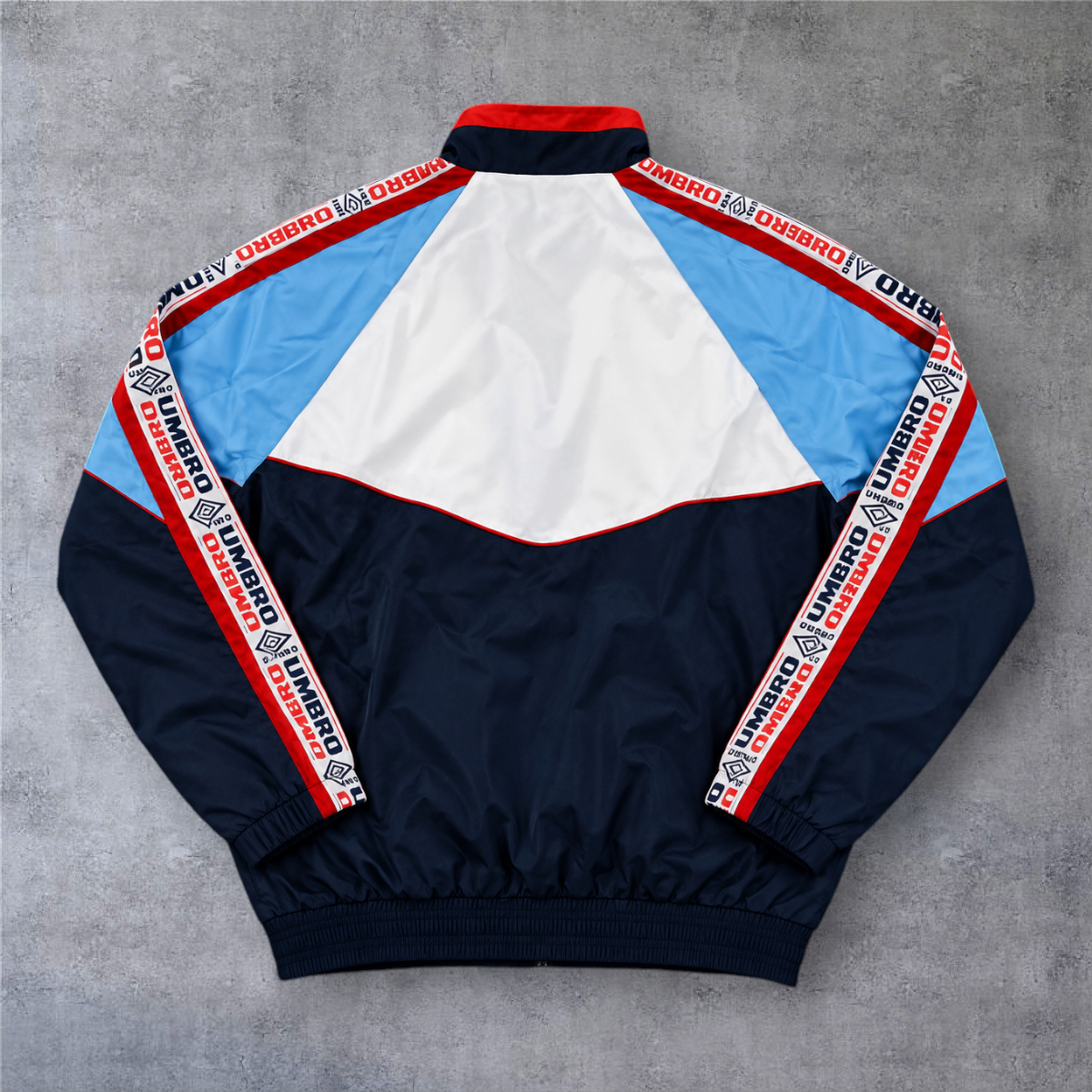 Casaco vintage A minha loja Celta de Vigo 1998/99, azul marinho, azul claro e branco com detalhes Umbro nas mangas.