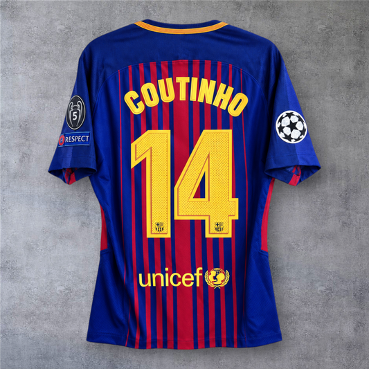 Camisola A minha loja do Barcelona 2017/18, modelo Coutinho 14, azul e grená com emblemas da Champions League.