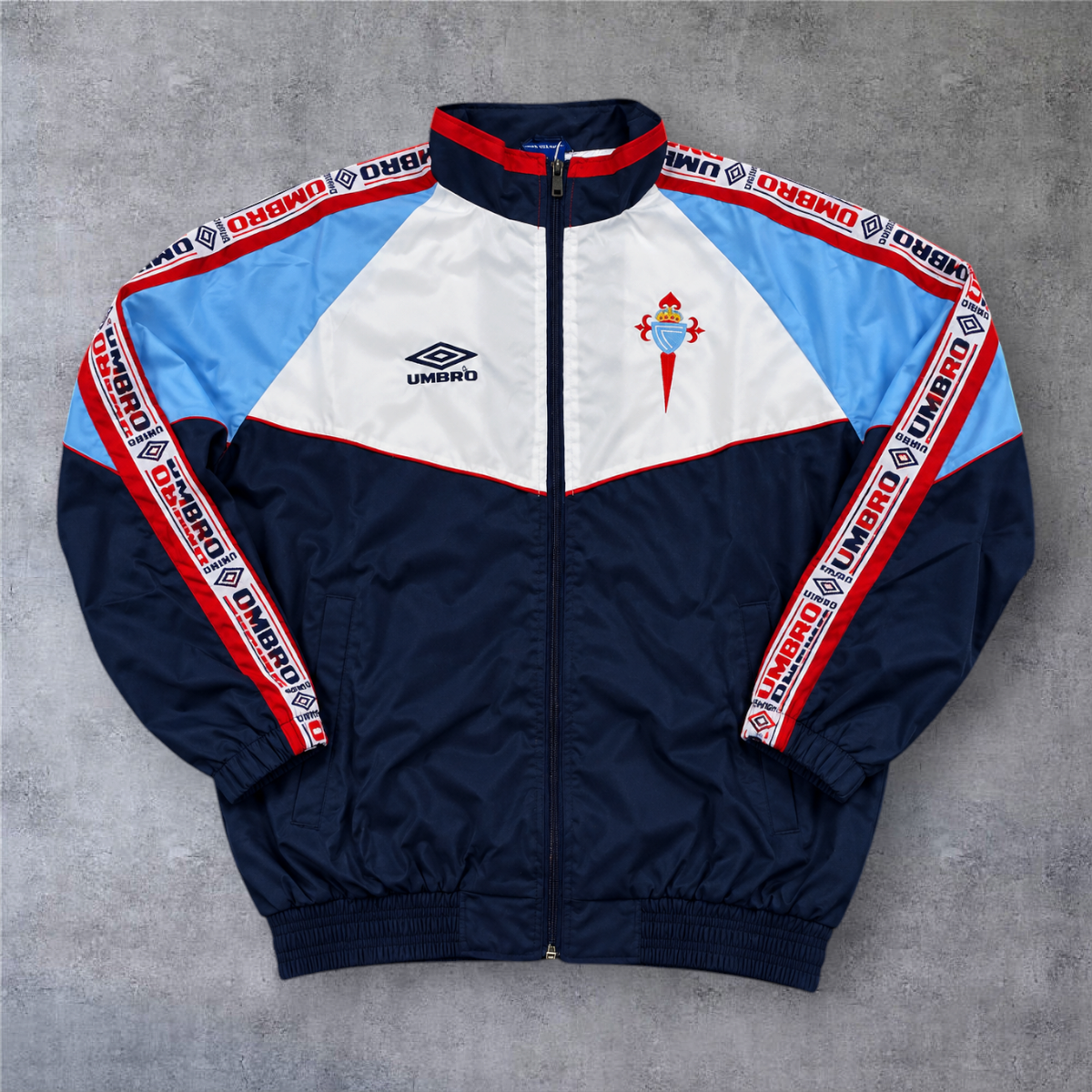 Casaco vintage A minha loja Celta de Vigo 1998/99, azul, branco e vermelho com fecho completo e logótipo Umbro.