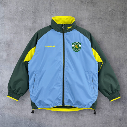 Casaco vintage Sporting 2003 A minha loja, azul e verde com detalhes em amarelo, fecho completo e emblema do clube.
